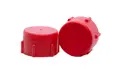Side-by-side view of two red, LDPE Unified Fine Thread threaded caps—one upright and one tilted to display the flat closed end.