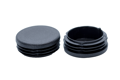 Two black plastic round tube inserts. Side by side, one is upside down.