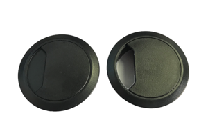 Pair of black plastic desk grommets with no background.