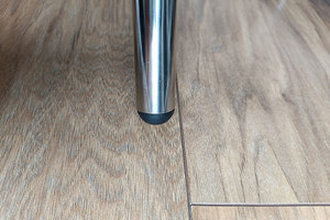 A chrome metal tube. Fitted with a black plastic round tube insert with a domed top, in the end of the tube.