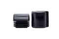 Black plastic chair feet, one standing on end do show the curved top and also the finned base.