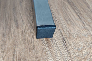 A square metal tube, fitted with a black plastic square tube insert.