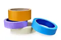 A collection of different coloured rolls of masking tape.