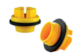 Two Yellow plastic metric threaded plugs with rubber sealing washers. At different angles.
