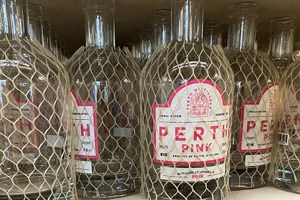 Bottles of Gin, covered in plastic protective netting.