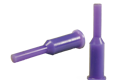 Two purple silicone plugs. With a tapered step in the middle and a small flange at the larger end.
