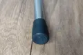 A round metal chair leg with a black heavy duty LDPE chair foot mounted to the bottom.