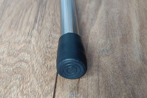 A round metal chair leg with a black heavy duty LDPE chair foot mounted to the bottom.