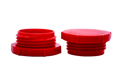 Two red plastic UNF threaded plugs. Both standing on opposite ends.