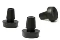 Three rubber push in feet. Two standing up and one on its side.