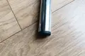 A round chrome metal tube with a black plastic tube insert fitted in the end.