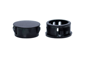 Two black plastic blanking plugs. Both standing up, showing opposite ends.
