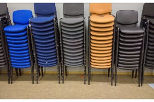 Piles of stacked chairs in various colours used to demonstrate stacking chair buffers.