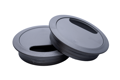 Grey plastic desk grommets stacked on each other with plain background.