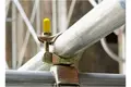 Scaffold clamp with yellow protection cap on the bolt.