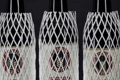Three bottles of wine, covered in white plastic protective netting.