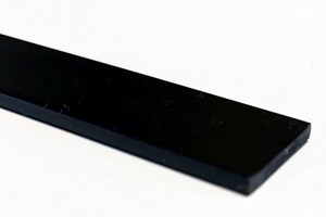 A close up of a flat plastic extrusion in black.