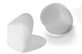 Pair of white foam corner protectors.