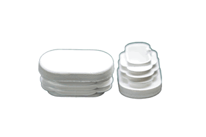 Two white plastic oval tube inserts. Both standing up, showing opposite ends.