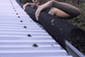 An arched plastic mesh, being fitted into a rain gutter.