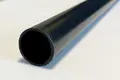 A close up view of a black plastic extruded round tube.