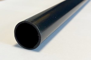 A close up view of a black plastic extruded round tube.