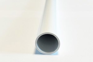A close up view of a white plastic extruded round tube.