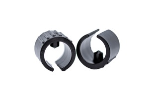 Angled view of two black plastic saddle feet with locating peg.