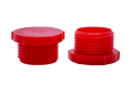 Two red plastic BSP threaded plugs. Both standing on opposite ends.