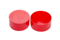 Side-by-side view of two round, red, LDPE injection moulded protective caps—one face down to show the STOCKCAP logo embossed on the closed end, and one upright.