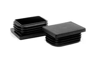 Angled view of two black rectangular LDPE tube inserts for table legs.