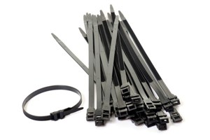 Black cable ties laying in a pile with a single one looped together.