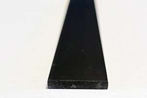 A front on, close up of a flat plastic extrusion in black.