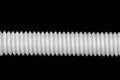 Close up of a threaded nylon rod.