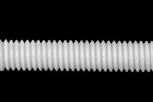 Close up of a threaded nylon rod.