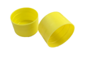 Pair of ribbed yellow plastic caps, used for scaffold protection.