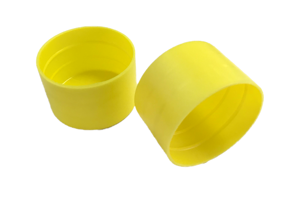 Pair of ribbed yellow plastic caps, used for scaffold protection.