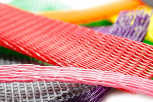 A selection of plastic protective netting. In various sizes. Pink, Red, Yellow, Orange, Grey and Green.