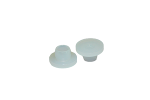 Two natural coloured plastic barrel plugs. Both standing up on opposite ends.
