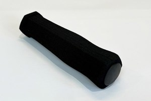 Diagonal view of a black high density foam extrusion moulded sleeve with a plastic end cap.
