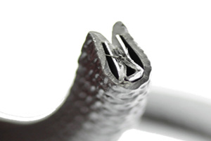 Rubber lined metal crimp in black rubberised strip for panel protection.