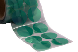 Green polyester masking discs on a clear liner. Arranged two wide on a roll.