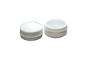 Angled front-top view of the cover sections of two white LDPE injection moulded secure nut and bolt cover caps.