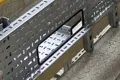 Metal tray for cabling with opening protected by flexible rubber grommet strip.