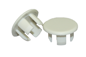 Two white plastic panel plugs. One standing up, one at an angle.