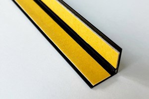 A right angled plastic extrusion in black. With Self adhesive tape fitted to both internal faces.