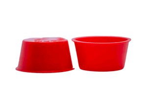 Two red plastic tapered plugs. Opposite ways up.