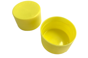 Close up of yellow plastic scaffold caps, one upright and one upside down.