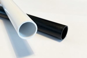 Two plastic extruded round tube profiles. One in white and one in black.