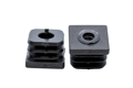 Two black plastic square tube inserts with threaded holes. Both standing up, showing opposite ends.
